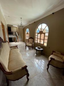 a large living room with two beds and a table at Riberas del Valle in Cuenca