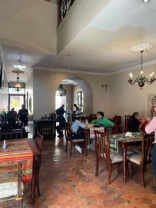 a group of people sitting at tables in a restaurant at Riberas del Valle in Cuenca