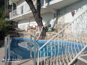 a staircase leading up to a house with a swimming pool at OLGA apartmani in Sutomore