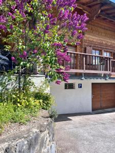a house with a tree with purple flowers on it at Himalayan vibes in Icogne +17 photos