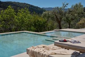 a swimming pool with a view of the mountains at Anemones Villas by Omikron Selections in Spanokhórion