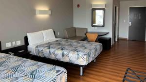 a hotel room with two beds and a desk at Motel 6-Weslaco, TX in Weslaco +22 photos
