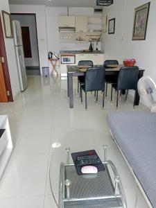 a room with chairs and a table with a remote control at Neo2 condo 703 in Jomtien Beach