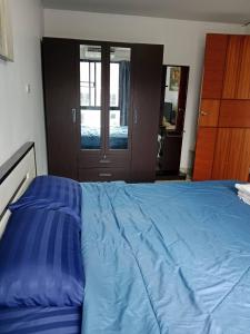 a bed with blue sheets in a bedroom with a door at Neo2 condo 703 in Jomtien Beach +11 photos