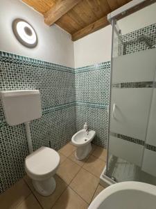 a bathroom with a toilet and a sink and a shower at Sicilia Bedda Holiday Home in Cinisi +31 photos