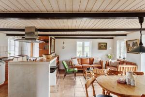 a kitchen and a living room with a table at 6707-Ronne-Kallokkevej-5 in Rønne