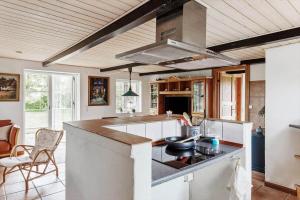 a kitchen with a large island with a stove at 6707-Ronne-Kallokkevej-5 in Rønne +12 photos