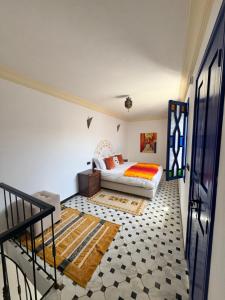 a bedroom with a bed and a staircase at Riad Zawia in Essaouira
