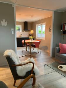 a living room with a table and a dining room at Bright and central apartment in Stavanger +12 photos