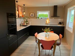 a kitchen with a table and chairs in a kitchen at Bright and central apartment in Stavanger