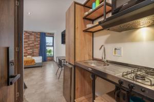 a kitchen with a sink and a stove at Appartments Pool and Rooftop Downtown Hotel in Medellín