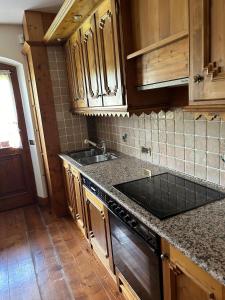 a kitchen with a sink and a counter top at Panorama Lodge in Cortina dʼAmpezzo +7 photos