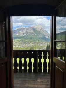 a view of a mountain from a window at Panorama Lodge in Cortina dʼAmpezzo