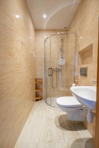 a bathroom with a shower and a toilet and a sink at Magdalena in Karwia +54 photos