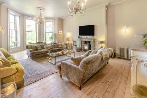 a large living room with couches and a fireplace at 4 Bed in Barnstaple oc-n34877 in Tawstock