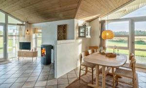 a kitchen and dining room with a table and chairs at VE087-Vejers-Strand-Jafdalvej-41 in Vejers Strand