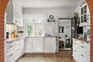a kitchen with white cabinets and a window at 80320-Ulfborg-Reberbanen-4 in Ulfborg