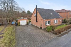 a red brick house with a white garage at 80320-Ulfborg-Reberbanen-4 in Ulfborg