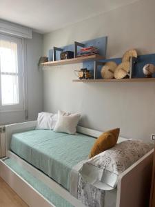 a bedroom with a bed and a window and shelves at Casa Viñao in Boborás
