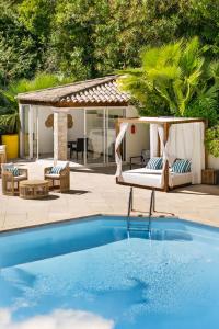 a backyard with a swimming pool and a gazebo at Sea View Villa Roc d'Azur - Pool - Jacuzzi in Vallauris