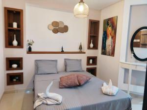 a bedroom with a bed with two towels on it at Beachfront Dream, WaveHaus in Akouda +89 photos