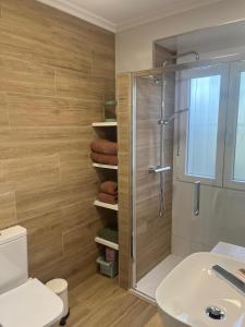 a bathroom with a shower and a toilet and a sink at Casa Viñao in Boborás +13 photos