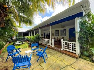 a group of blue chairs sitting on a patio at La Posada Azul Boutique Hotel Coco SA in San Juan del Sur