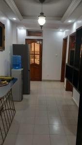 an empty kitchen with a refrigerator and a table at Elite appart in Dakar