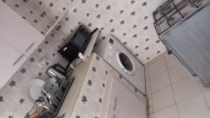a bathroom with a sink and a washing machine at Elite appart in Dakar