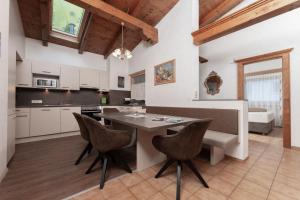 a kitchen with a table and chairs in a room at Appartement Gehörde-Sölden inklusive Summercard in Sölden