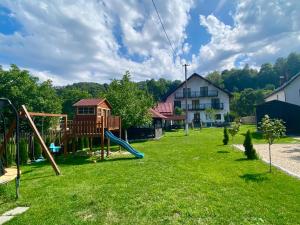 a playground with a slide in a yard at Balkanic Villa Bran in Bran