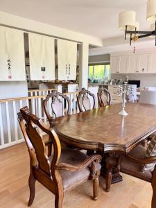 a dining room with a wooden table and chairs at Ivy s House in West Vancouver