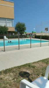 a swimming pool in a building with people in it at LaSpiaggia21 in Marotta