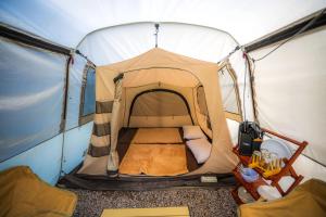 a tent with a bed inside of it at Ndalem Prabu in Sarangan