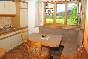 a kitchen with a table with a bowl of fruit on it at Gästehaus Nigg in Eisenberg