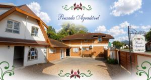 a house with a driveway in front of it at Pousada Agradável Pomerode in Pomerode