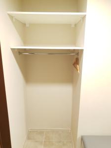 a walk in closet with white walls and white shelves at Ezerkrasts Daugavas 7 in Liepāja