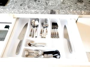 a drawer filled with utensils in a kitchen at Ezerkrasts Daugavas 7 in Liepāja