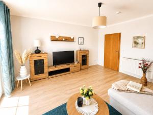 a living room with a couch and a tv at Ferienwohnung Rita Usedom in Korswandt