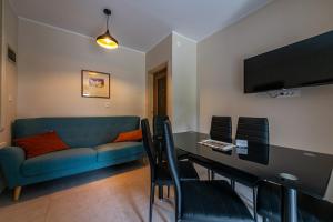 a living room with a blue couch and a table at Green Oasis with Terrace in Pazin