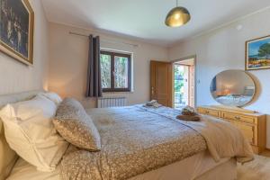a bedroom with a large bed and a mirror at Green Oasis with Terrace in Pazin