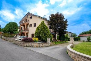 a house with a car parked in the driveway at Green Oasis with Terrace in Pazin