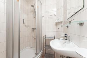a white bathroom with a sink and a shower at Appartement Gehörde-Sölden inklusive Summercard in Sölden +40 photos