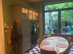 a dining room with a table and a window at Room in a garden Late CHECKOUT in Ghent