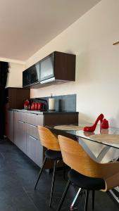 a kitchen with wooden cabinets and a table and chairs at Sadowa Ostoja z prywatnymi jacuzzi in Pierwoszyno