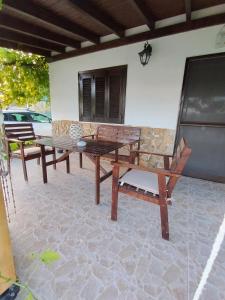 a wooden table and benches on a patio at Tiny Loft House in Halkidiki in Nea Potidaea
