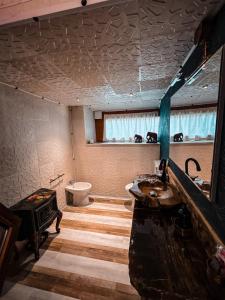 a bathroom with two sinks and a toilet in it at Smith's house in Borgo San Dalmazzo