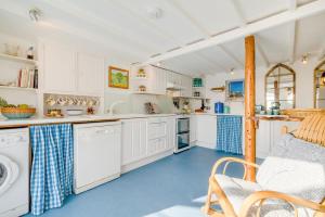 a kitchen with white cabinets and a blue floor at 3 Bed in Tintagel oc-trev5 in Treknow +44 photos