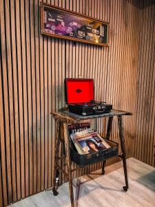 a table with a red laptop on top of it at Smith's house in Borgo San Dalmazzo