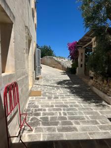 a red bench sitting on the side of a street at Masseria Pelosella B&B in Fasano